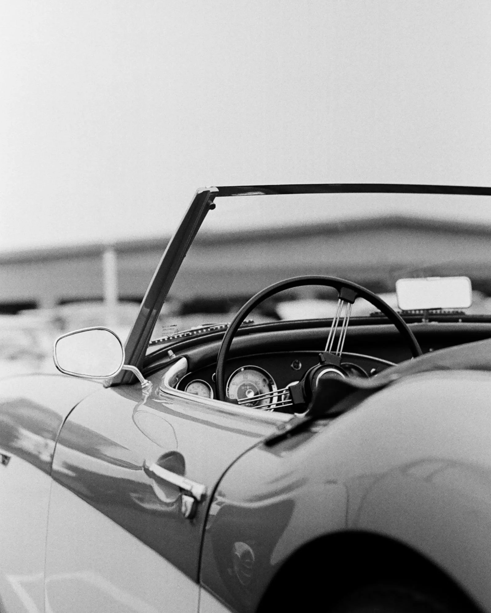 A black and white photograph of a classic car