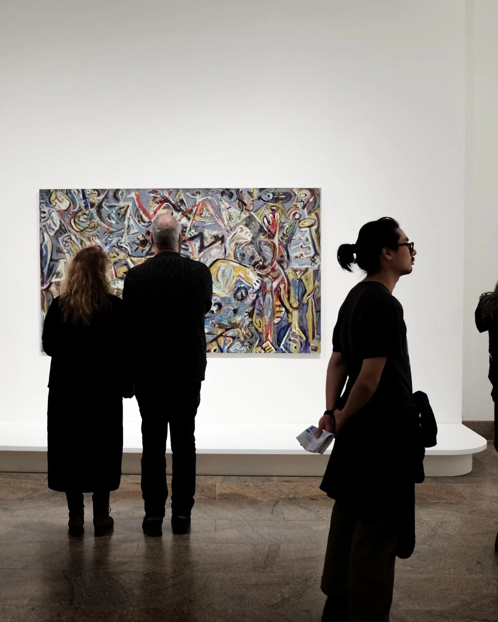 A room hung with framed paintings