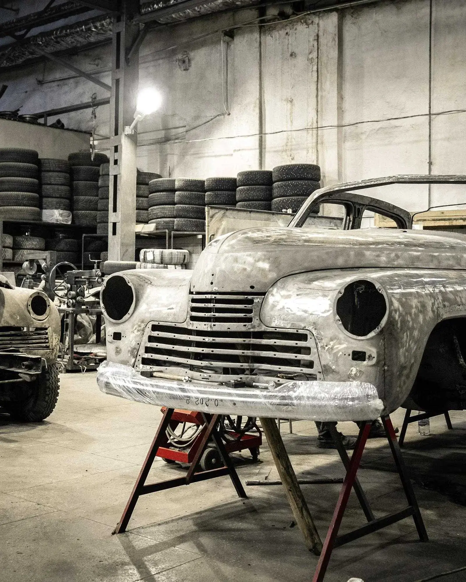 A classic car body under restoration in a workshop
