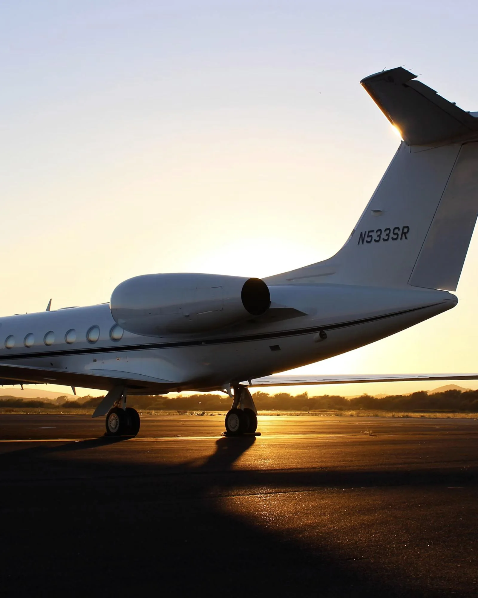 A private jet parked on an airport apron